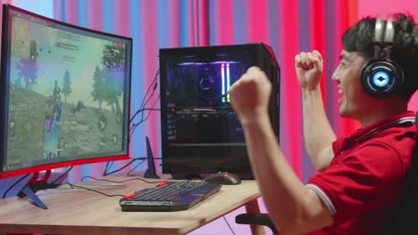 Excited Man Playing Survival Shooter Games On Computer