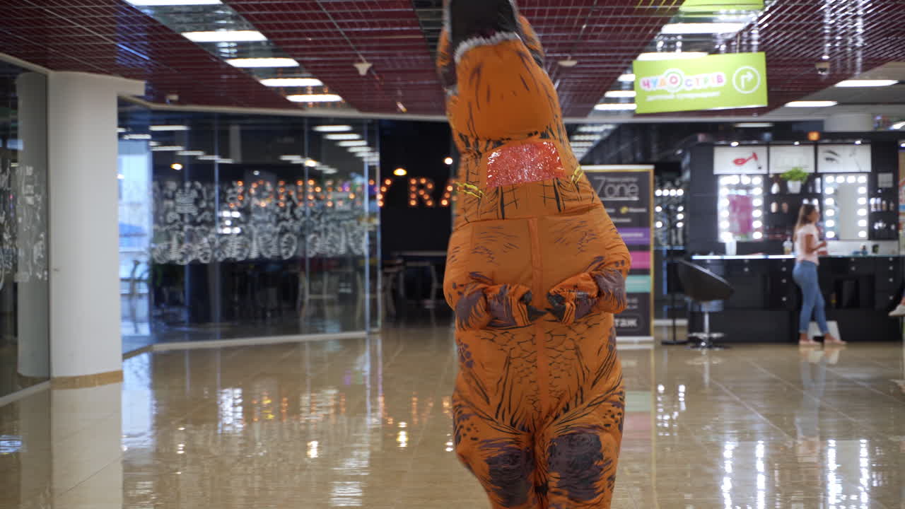 Person in a Dinosaur Costume in a Shopping Mall
