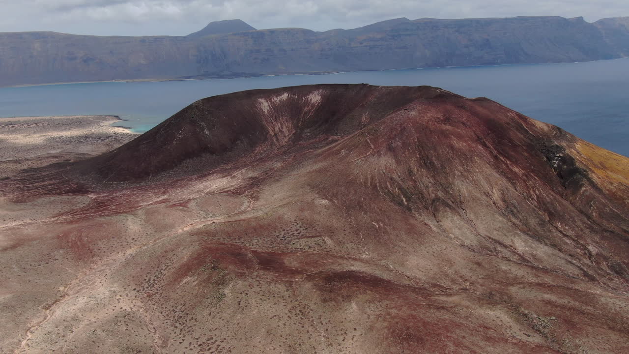 Aerial view of the volcanic crater of mountain Bermeja on the island of La Graciosa, Spain