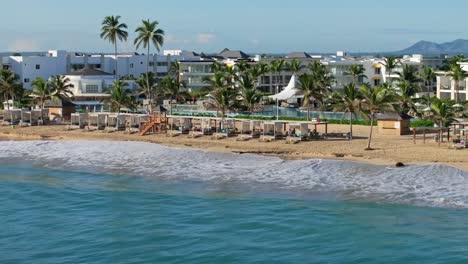 Ocean-Waves-on-the-Shoreline-Of-the-Beach-With-Cottages-In-Nickelodeon-Hotels-And-Resorts-Punta-Cana-In-Dominican-Republic