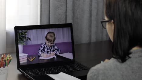 woman teacher makes video call on laptop with children pupil. distance education