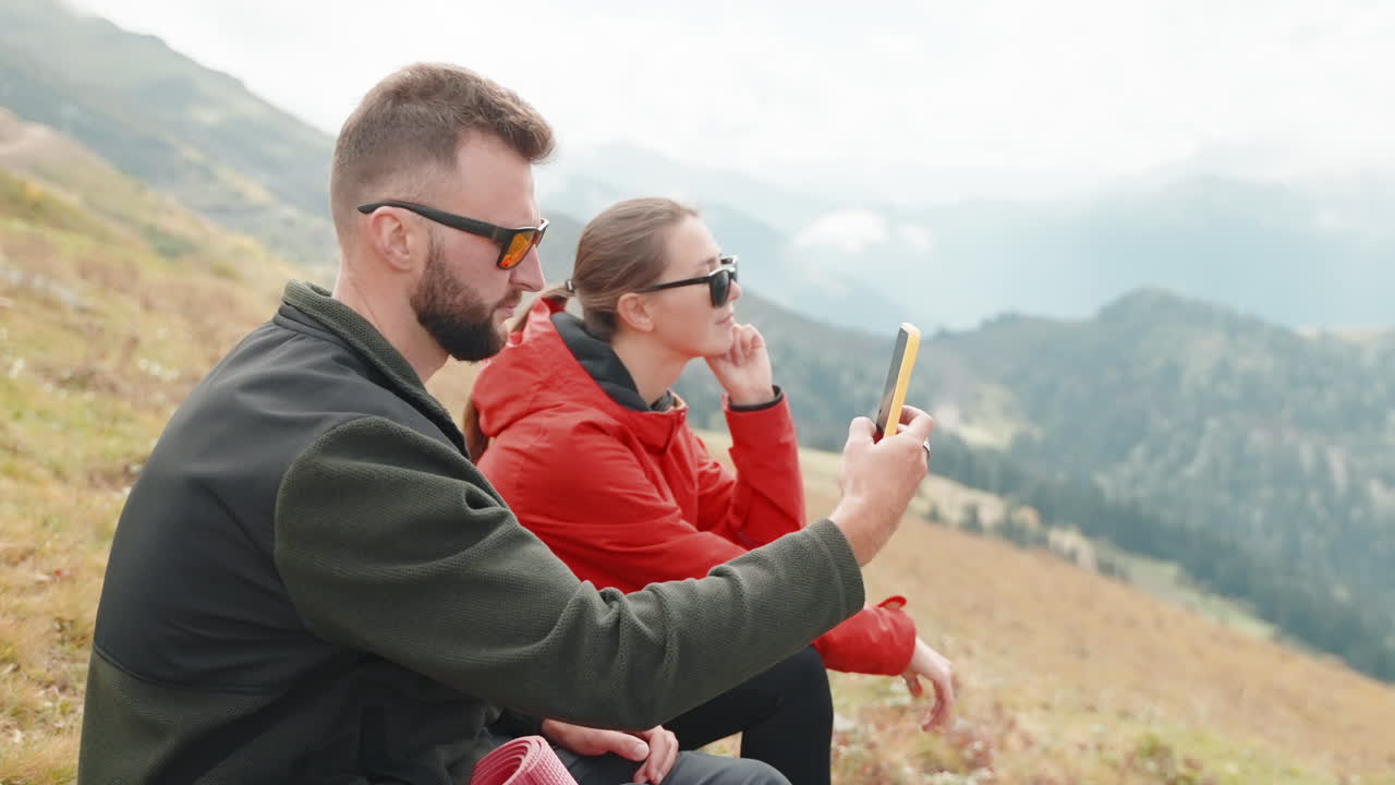 пара фотографируется в горах.