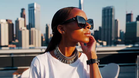 stylish woman on rooftop city view