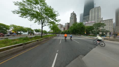chicago cyclists riding southbound on dusable lake shore drive during bike the drive 2022 biking past john hancock tower center michigan avenue magnificent mile oak street beach skyscraper clouds