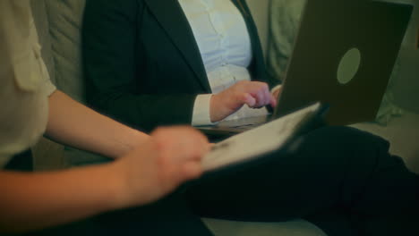 woman discusses notes with business partner at home