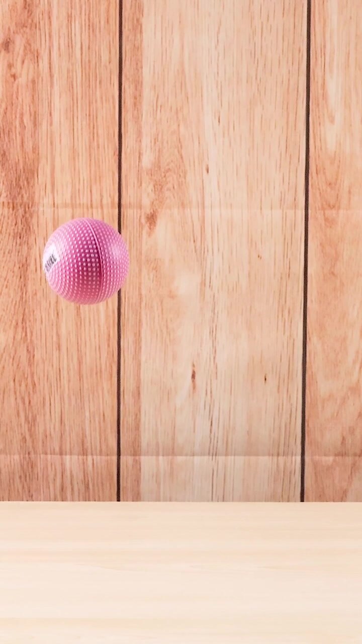 A ball bounces repeatedly on a wooden surface
