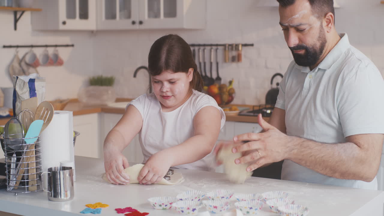 a Father Watches his Daughter Doing a Cartwheel in an Airport Terminal Preparing for a Flight a Father and Daughter Share a Playful Moment at an Airport with the Little Girl Doing a Cartwheel as they Wait for their Flight