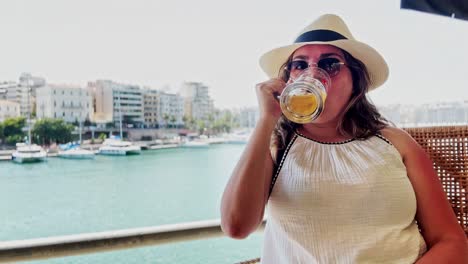 cheers from greece: vlogger with beer at marina cafe