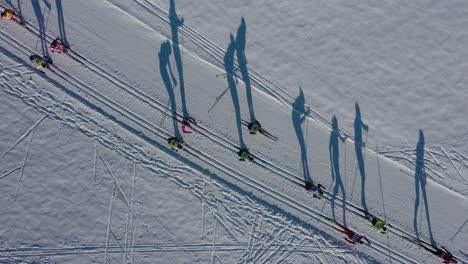 aerial top down of race between athletes skiers in the mountains