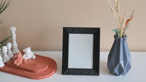 simple home decor with a black frame and vase