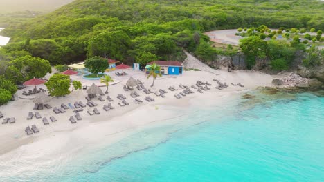 aerial descend and orbit of grote knip in curacao with turquoise waters, sandy shoreline, and tropical greenery