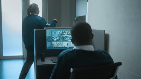 security guards monitoring surveillance cameras in control room