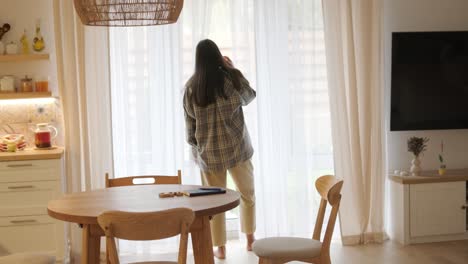 a beautiful pregnant woman sitting comfortably at home, enjoying video games on a tv console. the scene blends relaxation, modern entertainment, and maternity in a cozy setting