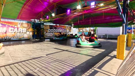 people enjoying bumper cars at a fun fair