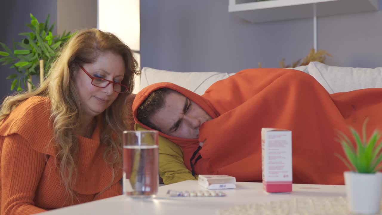 Madre che dà la medicina al figlio malato.