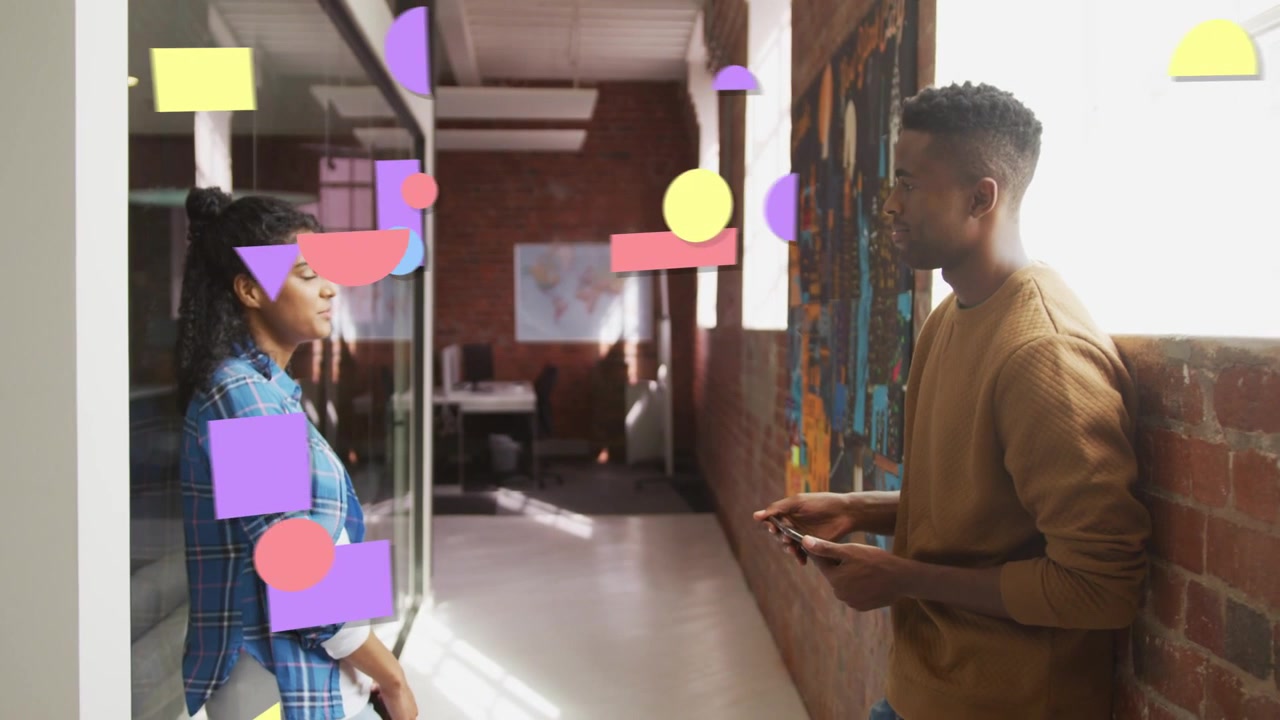 Man glancing at phone, looking up, creative team sharing design idea, pastel shapes obscuring pair