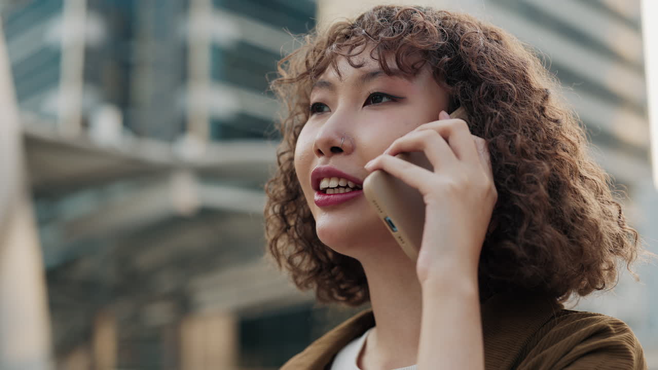 Young woman talking on phone outdoors