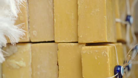 stacked bars of yellow soap with turkish eye decorations