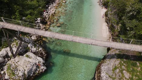 a beautiful drone shot of the soča river with a bridge