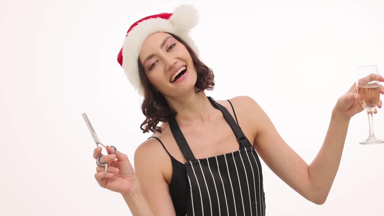 Festive Hairdresser in Santa Hat Toasting with Champagne and Scissors