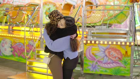 two friends hugging at an amusement park
