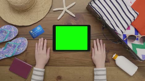 aerial footage of woman using digital tablet by beach supplies