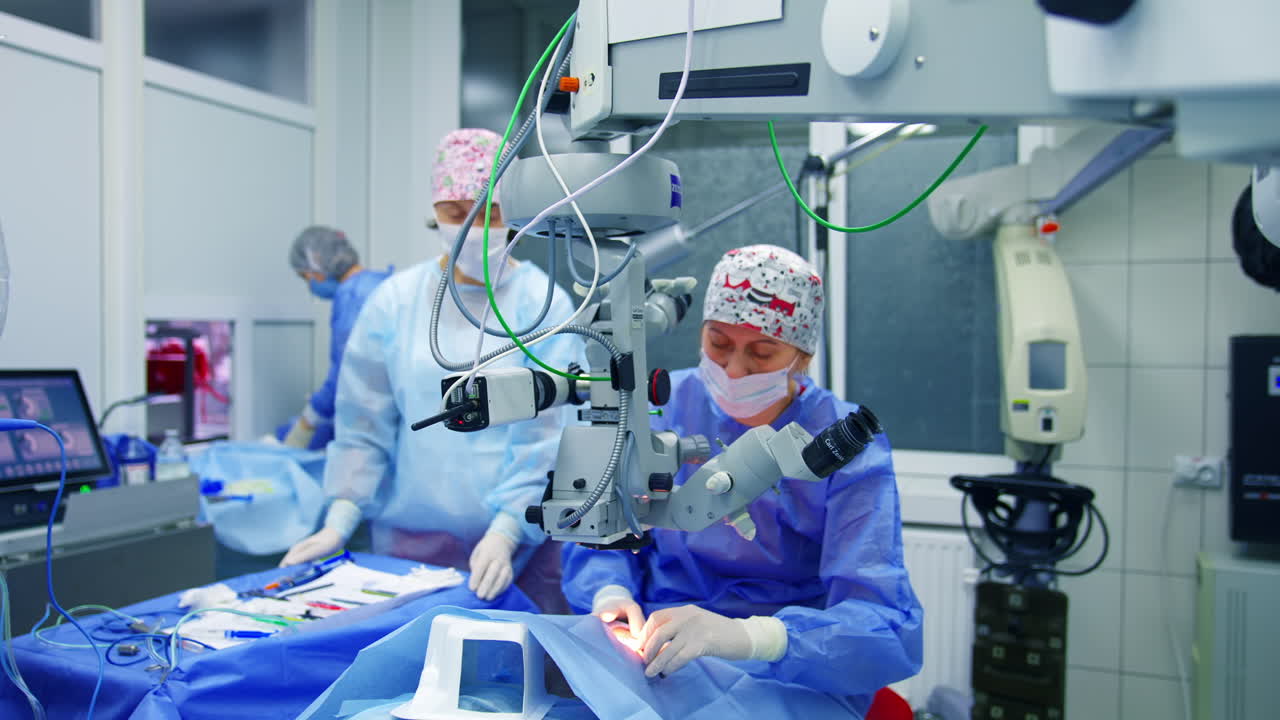 Medical team performing operation. Patient and surgeons in the operating room during ophthalmic surgery