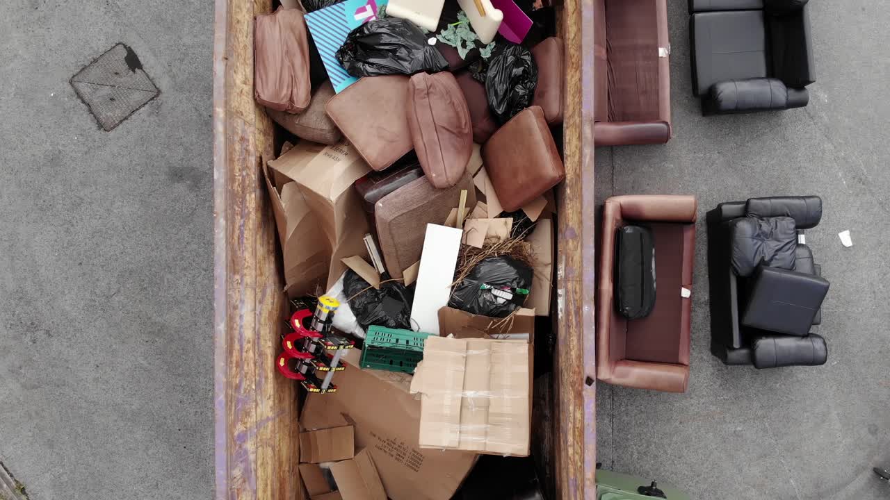 Big Industrial Skip Full Of Old Furnitures And General Waste. - top view shot