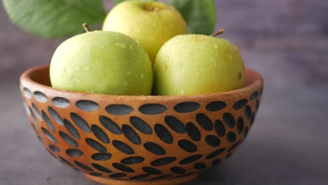 green apples in a wooden bowl