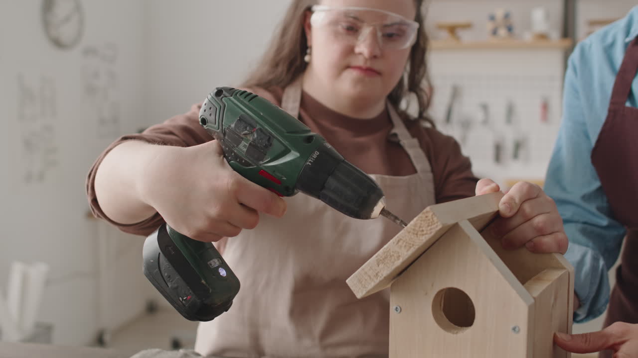 Woman with Down Syndrome Building a Birdhouse