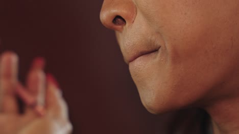 Close-up of a woman applying makeup
