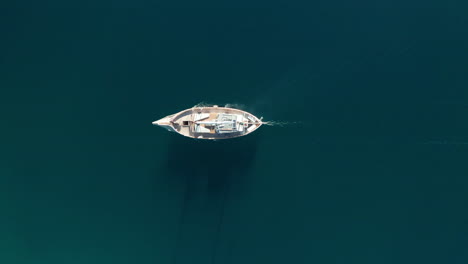 aerial - sailboat on correntoso lake, neuquen, argentina, top down tracking shot