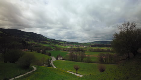 landscape surrounding gruyères, switzerland, on a cloudy day