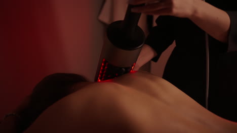 woman receiving red light therapy massage at spa