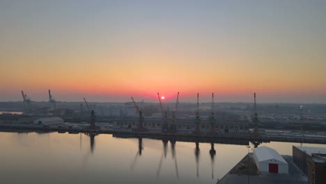 shipyard cranes during a sunrise, aerial szczecin city