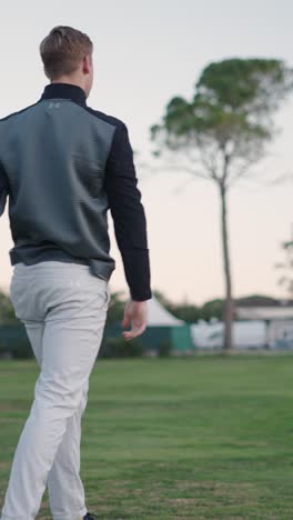 A Golfer Playing Golf on a Green Course