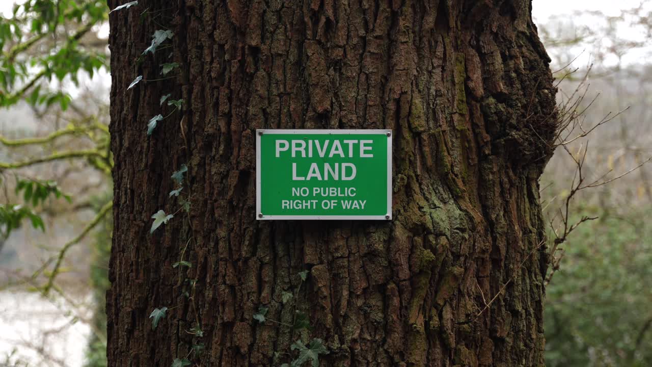 Green private land no public right of way sign mounted on tree