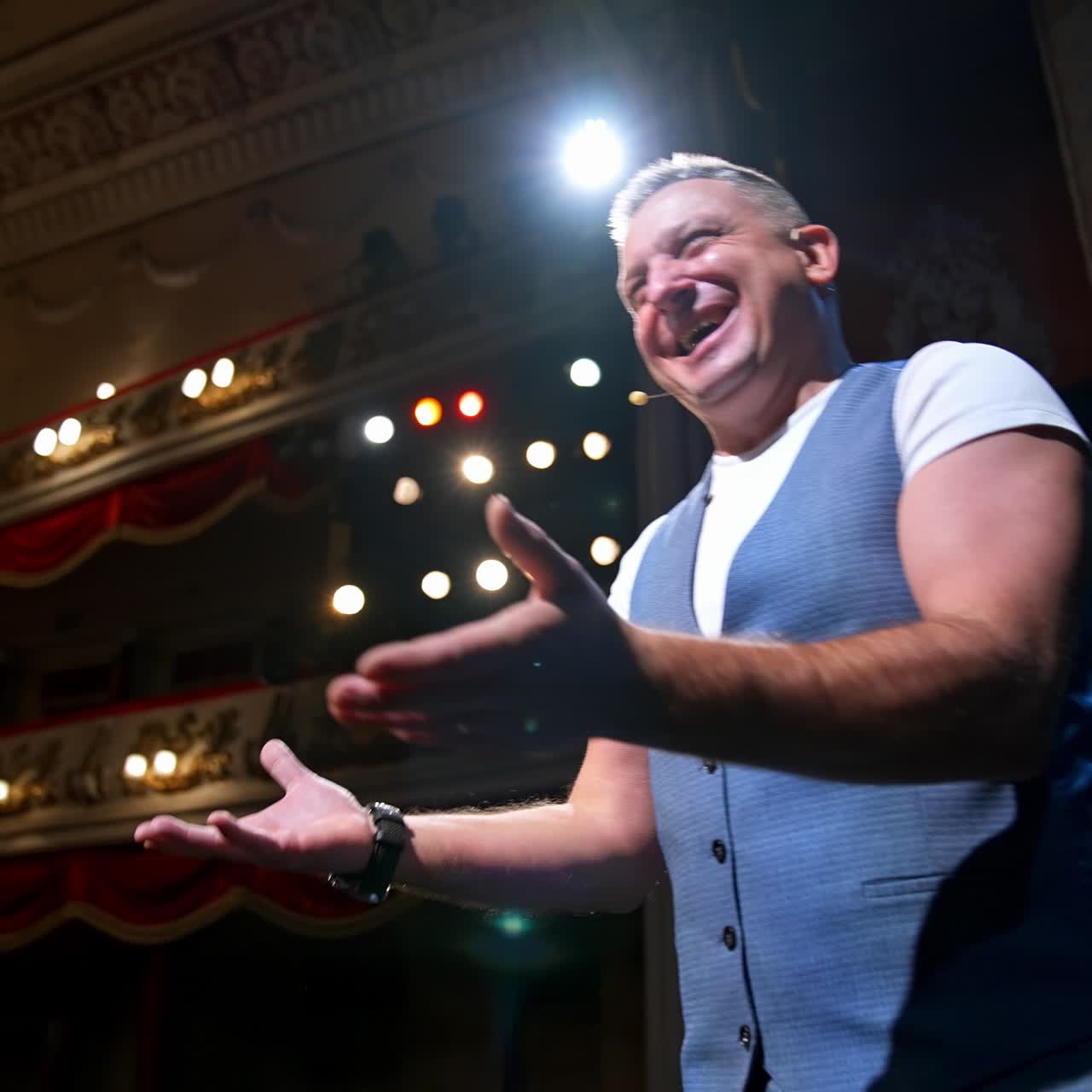 Leading man on stage of theatre