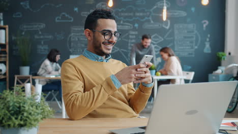 man using smartphone in a modern office setting