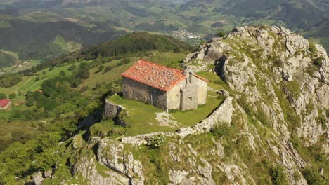 aerial drone view of the hermitage of santa eufemia on the top of a mountain in aulestia in the basque country