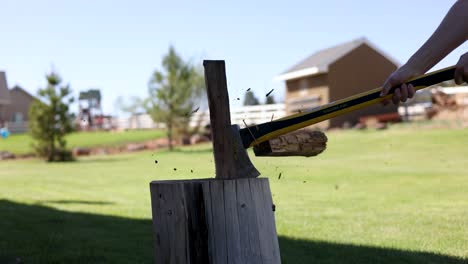 Closeup-of-Wood-Log-on-Stump-Being-Chopped-by-Axe-for-Firewood