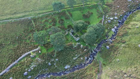 Ireland-mountains-Comeragh-Mountains-Waterford-drone-circling-ruined-farmstead-near-a-stream-at-sunset-on-a-summer-evening