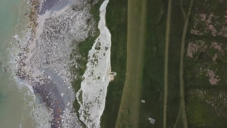 Edge-of-Beachy-Head-tall-chalk-cliffs,-English-coastline,-aerial-bird's-eye-view