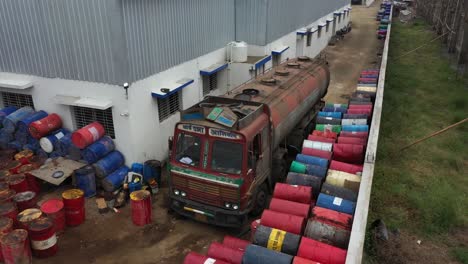 tanker truck delivering oil barrels to factory