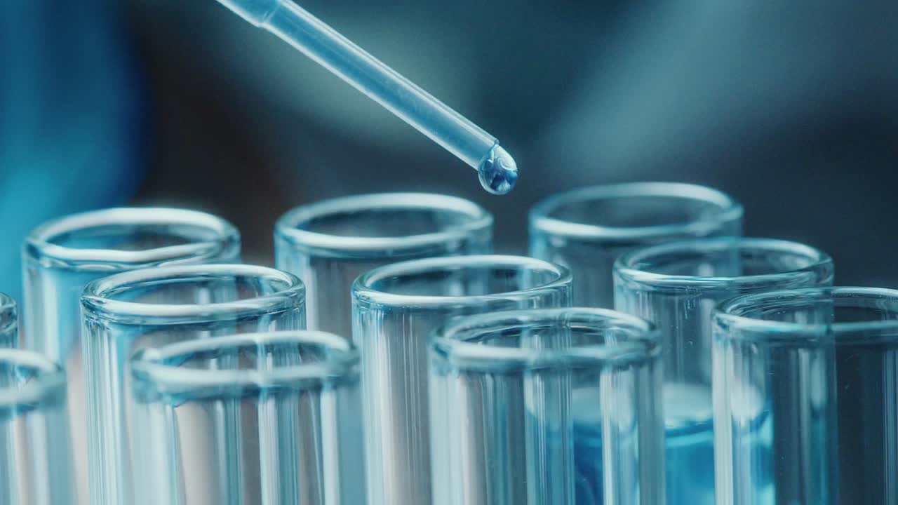 Dropper adding liquid to test tubes