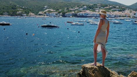 a woman in a summer dress stands on the beach 2