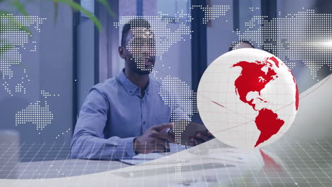 discussing global data, businessman using animation with world map overlay in office