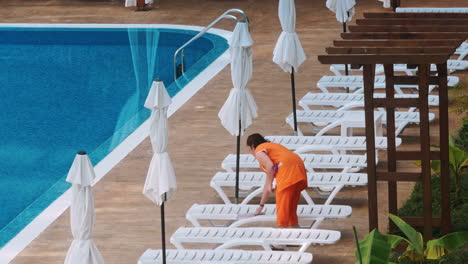 worker is cleaning near swimming pool