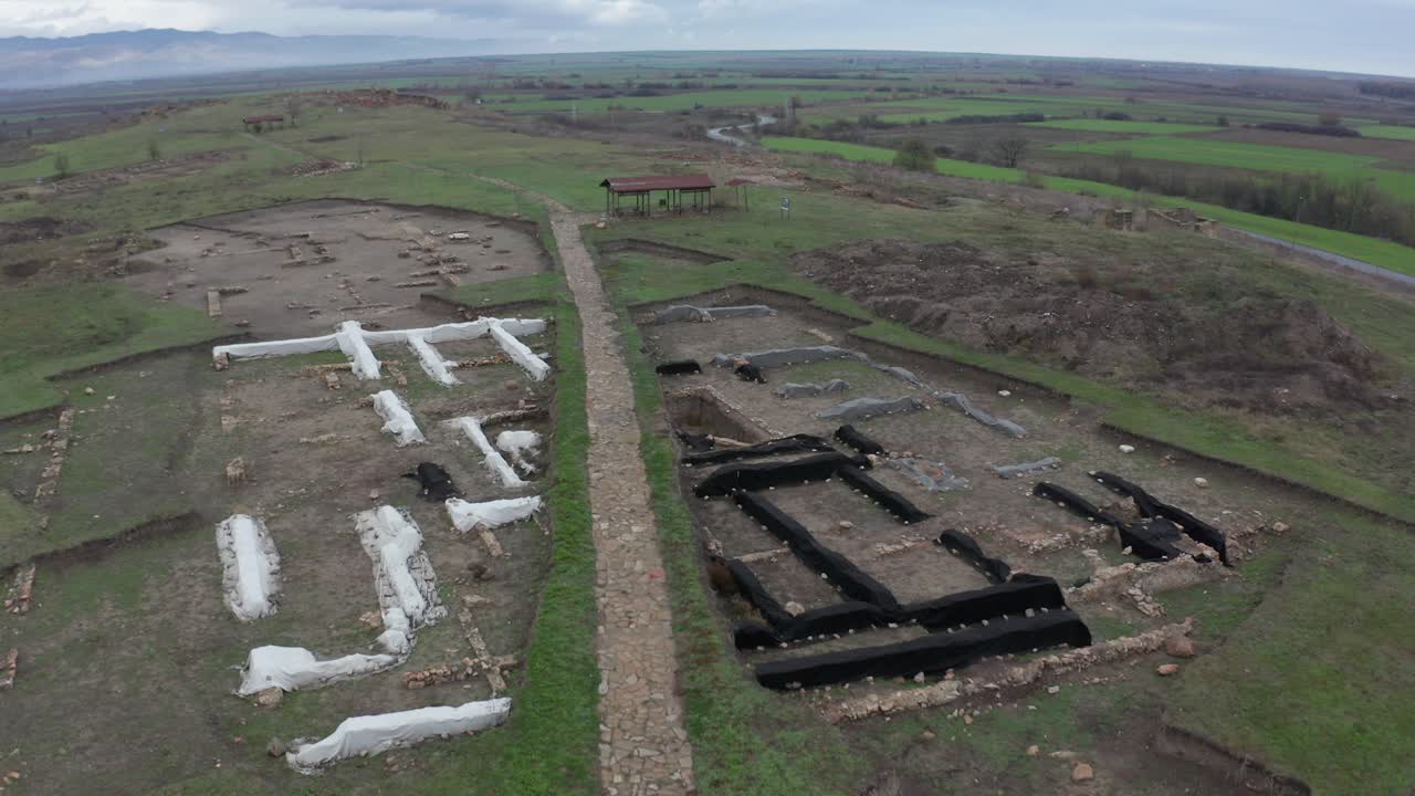 A bird's eye view of ancient ruins in an empty field in Bulgaria