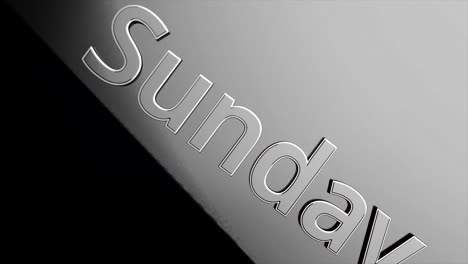 close-up of a sunday text on a metal surface